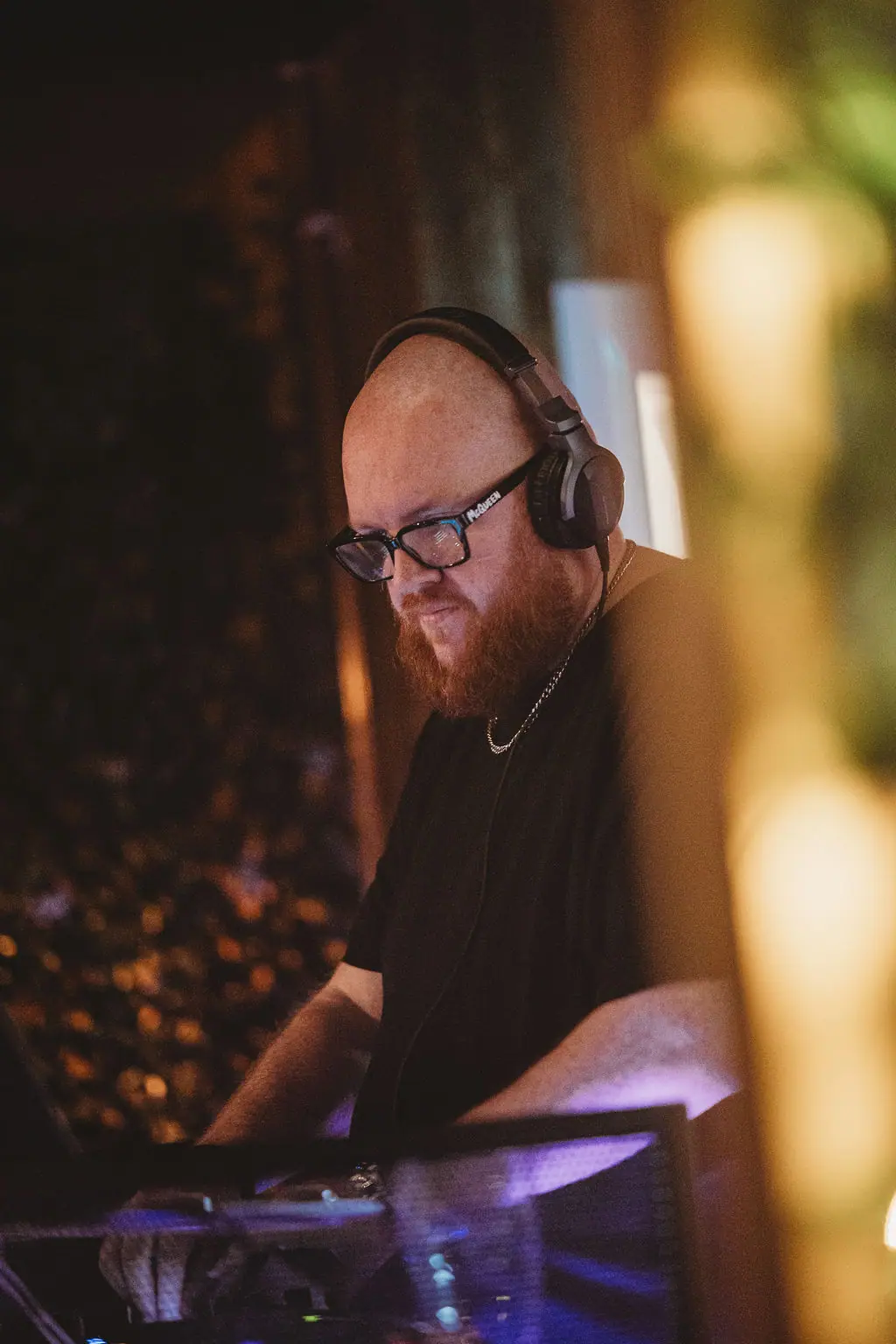 The DJ in headphones at the decks at The Teal Monkey