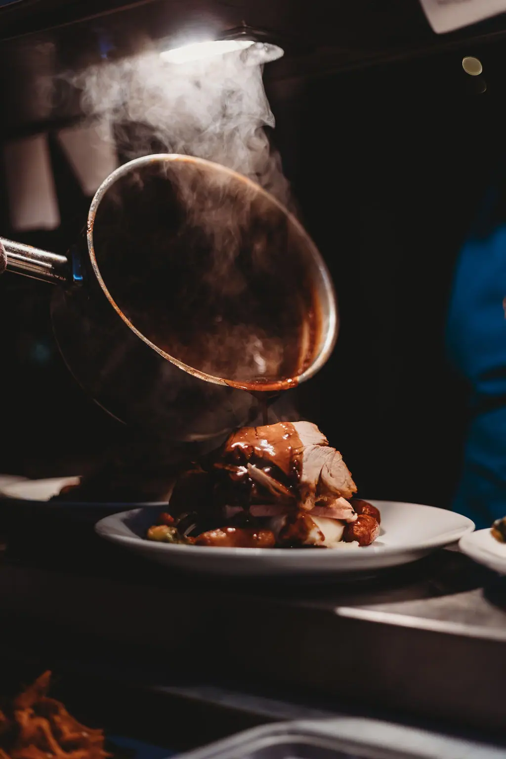 Gravy being poured over a Christmas dinner